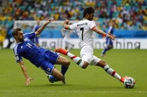 Iran's Shojaei clears the ball past Bosnia's Sven Susic during their 2014 World Cup Group F soccer match at the Fonte Nova arena in Salvador