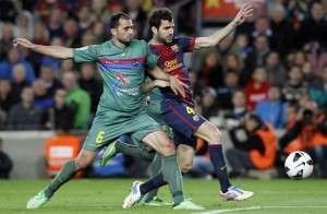 Barcelona's Fabregas fights for the ball against Levante's Vyntra during their Spanish First division soccer league match at Camp Nou stadium in Barcelona